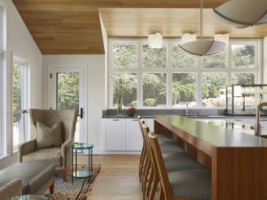 Bright and airy eat-in kitchen bar with small sitting area to the left.